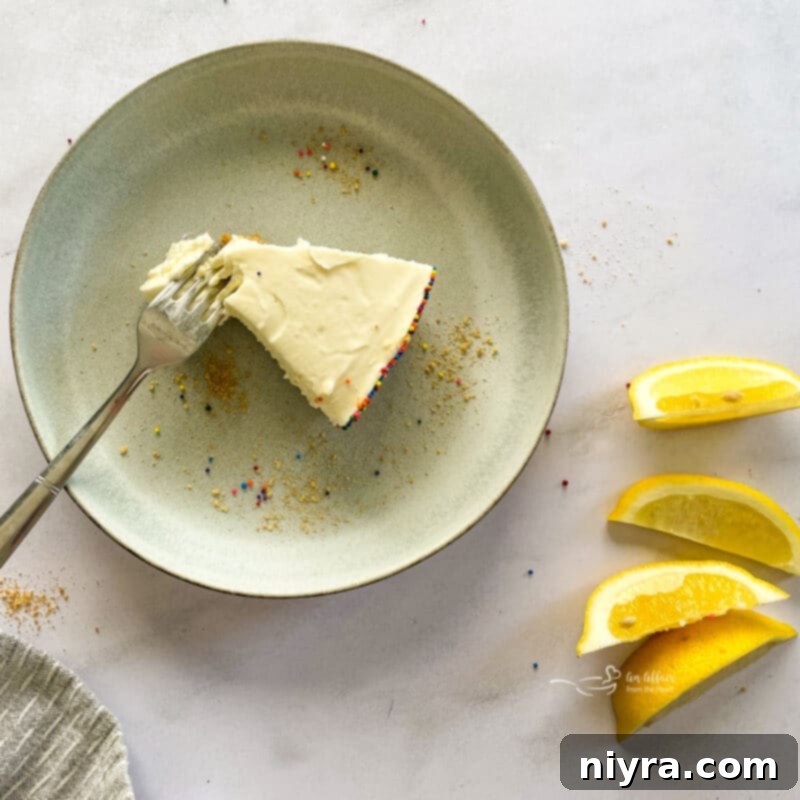 No-Bake Marshmallow Cheesecake garnished with lemon slices and mint leaves.