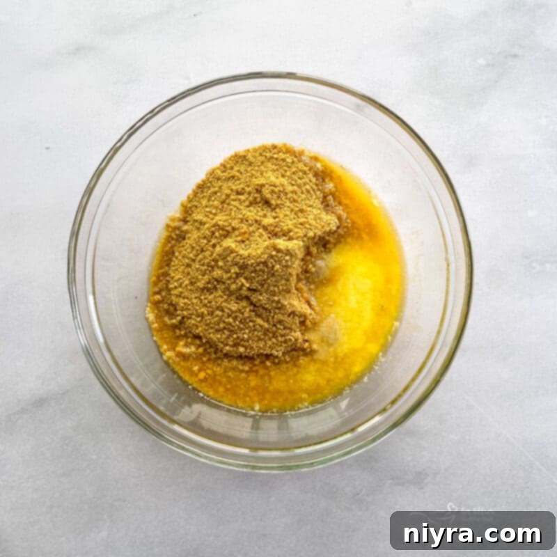 A mix of crushed animal cookies and melted butter for the cheesecake crust.