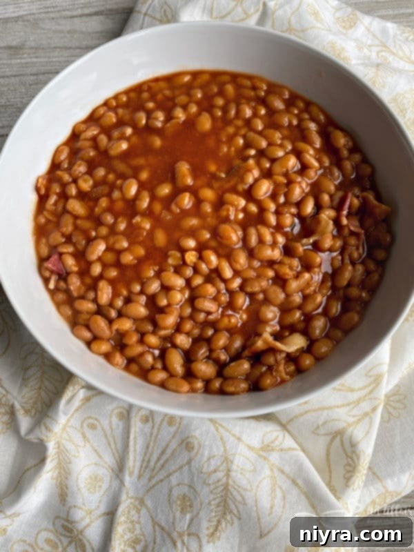 Close-up of Grandma's Baked Beans in a white bowl.