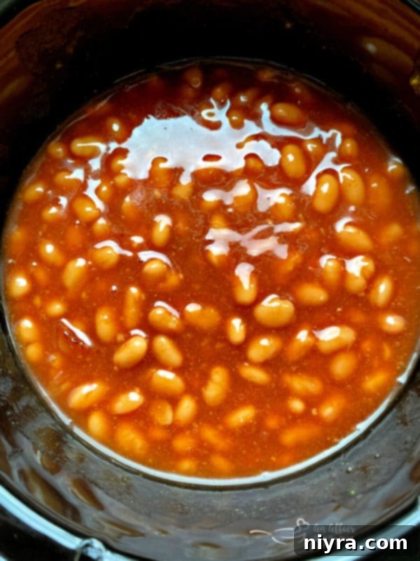 Slow cooker filled with Grandma's Baked Beans.