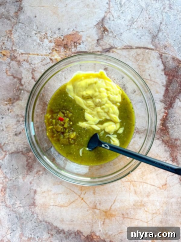 Step-by-step image showing sauce poured over chicken in the slow cooker