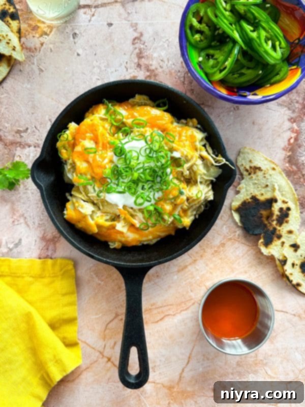Close-up of a serving of Slow Cooker Green Chile Chicken Enchilada Casserole ready to eat