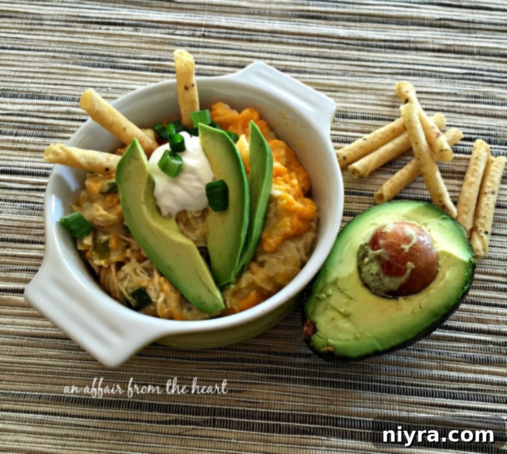 Slow Cooker Green Chile Chicken Enchilada Casserole in a serving dish, ready to eat