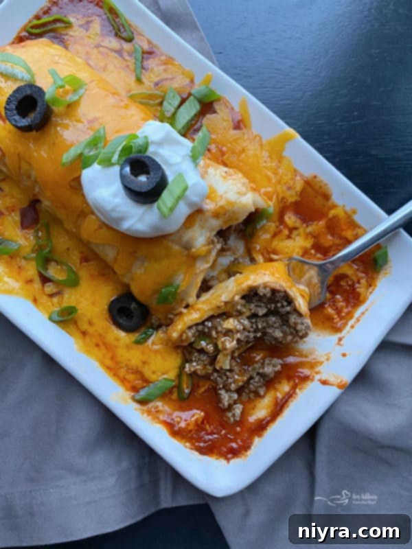 Overhead of a fork taking a bite from a Copy Cat Taco Bell Enchirito