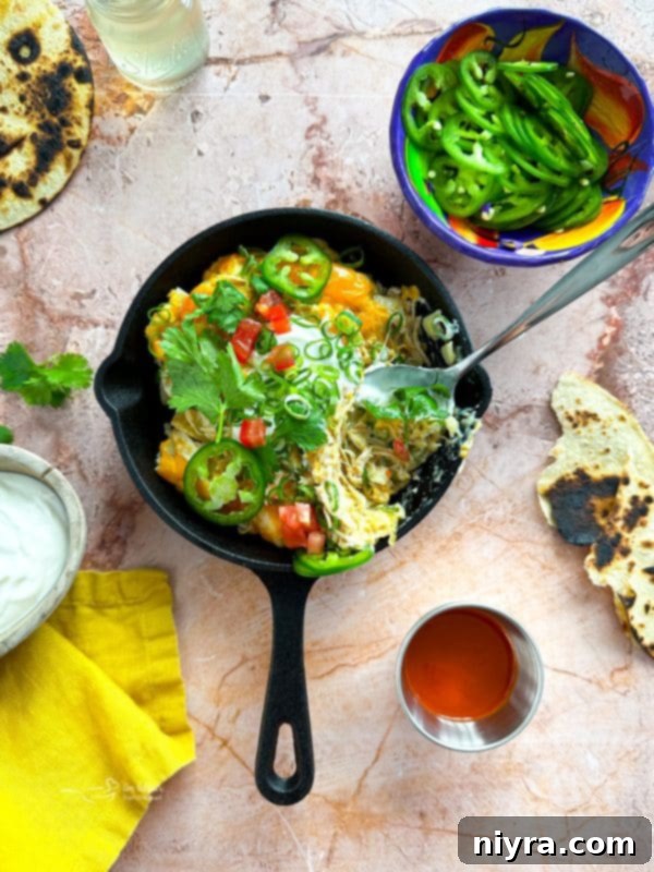 Overhead shot of Slow Cooker Green Chile Chicken Enchilada Casserole in the slow cooker before serving