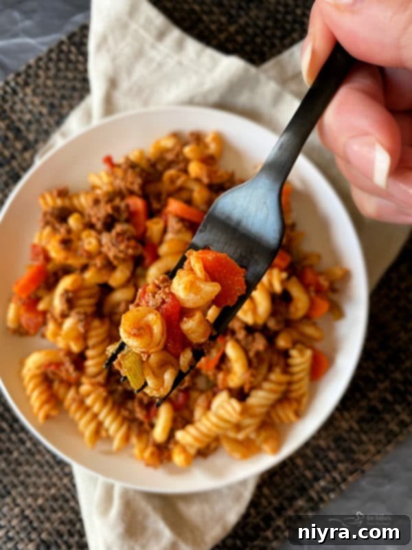 Fork lifting a spoonful of American Goulash