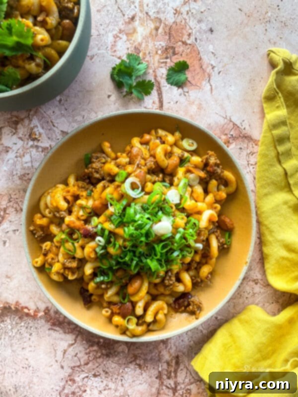 Chili Mac Skillet in a pan with a serving spoon
