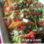 Baked shredded beef tacos on a white platter with text "baked shredded beef tacos"