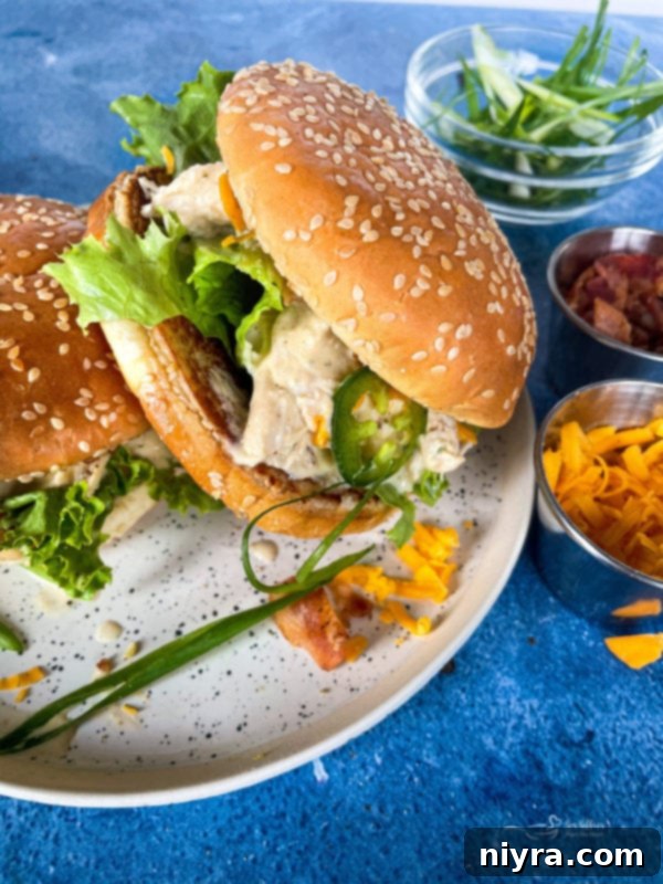Crack chicken served on a sesame seeded bun with lettuce and tomato.