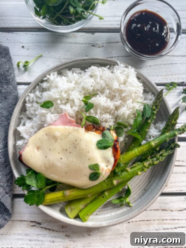 Close-up of grilled chicken breast with melted provolone cheese bubbling on top.