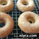 Donuts on a cooling rack with text "baked banana donuts"