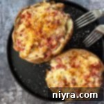 Close up of 2 Reuben stuffed baked potatoes