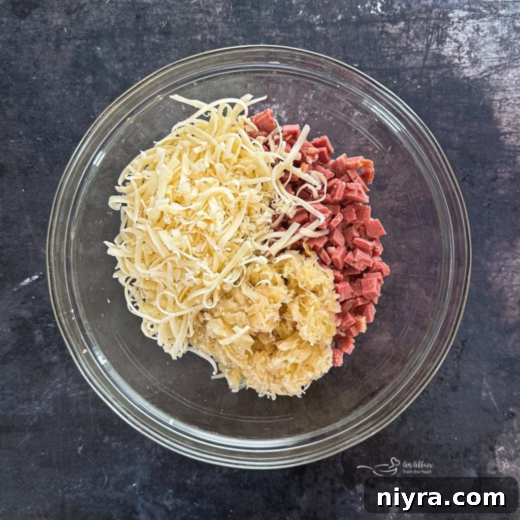 A bowl with corned beef, Swiss cheese, and sauerkraut mixed together