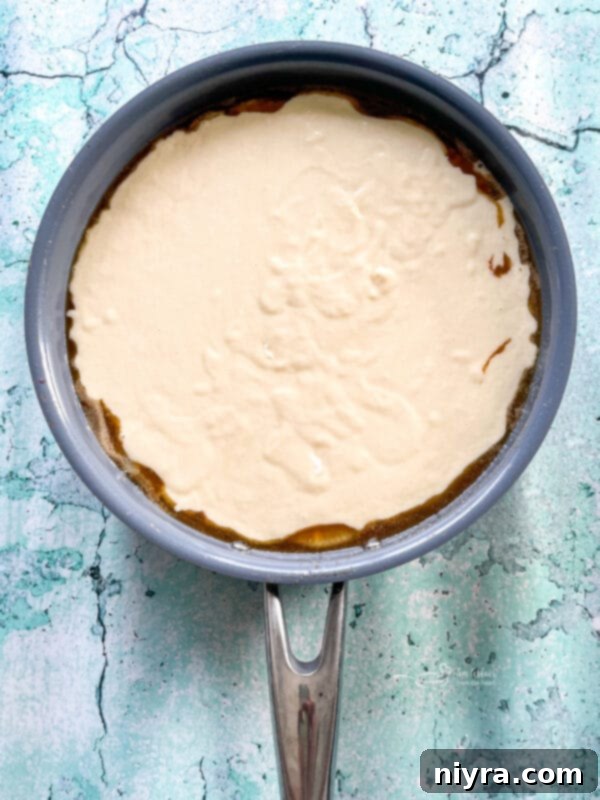 Homemade Pineapple Upside Down Cake 15 Arranging pineapple and cherries in the skillet