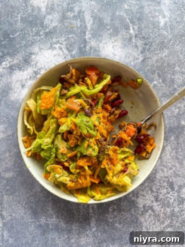 Aunt Sue's Ultimate Doritos Taco Salad 11 A large serving bowl of Doritos Taco Salad, viewed from above, showcasing the colorful ingredients and crushed chips.