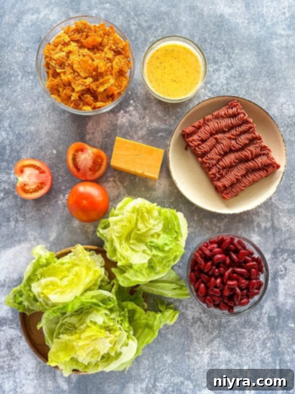 Aunt Sue's Ultimate Doritos Taco Salad 4 A large mixing bowl filled with Doritos Taco Salad, featuring visible Doritos chips, lettuce, ground beef, and cheese.