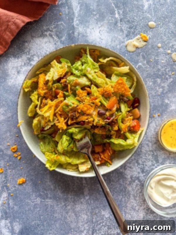 Aunt Sue's Ultimate Doritos Taco Salad 5 A bowl of freshly shredded cheddar cheese, ready to be added to the Doritos Taco Salad.