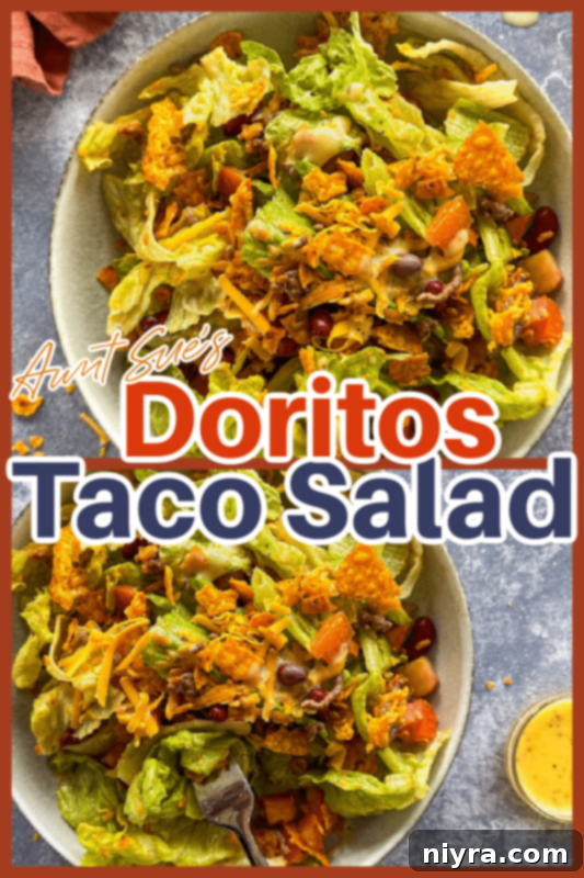 Aunt Sue's Ultimate Doritos Taco Salad 10 A bowl of Aunt Sue's Doritos Taco Salad, with a fork, ready to be eaten. A full bag of Doritos is in the background.