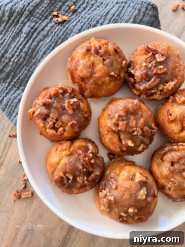 A plate of fluffy banana bread cinnamon rolls with pecan glaze.