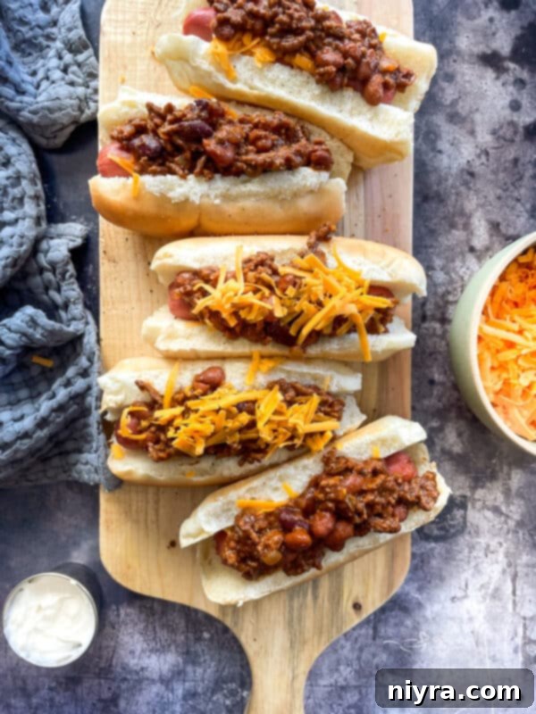 Delicious Chili Cheese Dogs on a serving board
