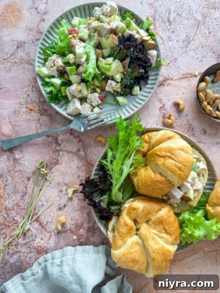 A vibrant Apple Chicken Salad, featuring crisp apple pieces and toasted cashews, served in a bowl, highlighting its fresh ingredients and inviting texture.
