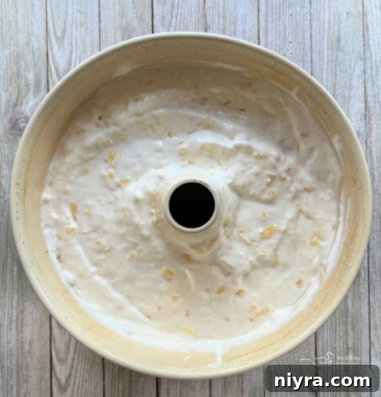 Electric mixer beating the angel food cake batter to a fluffy consistency