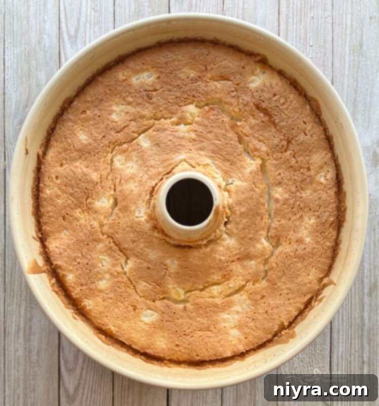 Pouring the fluffy angel food cake batter into an ungreased tube pan