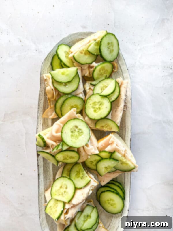 Close-up of a perfectly layered Turkey Ranch Baguette slice, showcasing the filling.