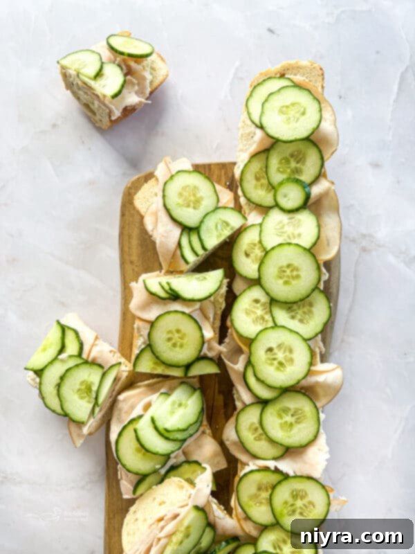 A close-up of Turkey Ranch Baguettes, showcasing the layers of turkey and cucumber.
