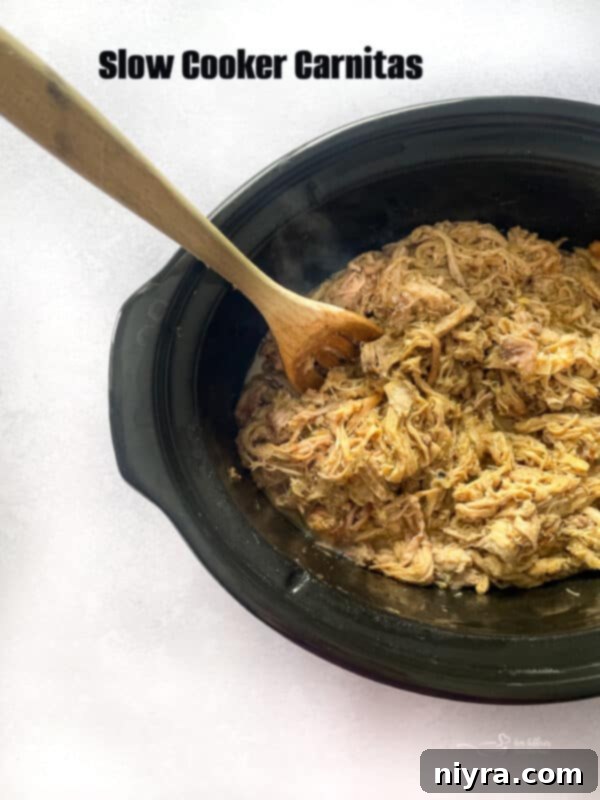 Hero image for Slow Cooker Carnitas, featuring a close-up of the shredded pork