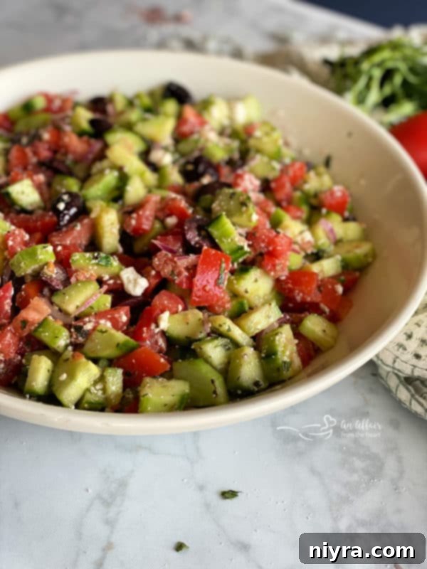 Refreshing Greek Cucumber Salad 11 Side view of cucumber Greek salad in white bowl