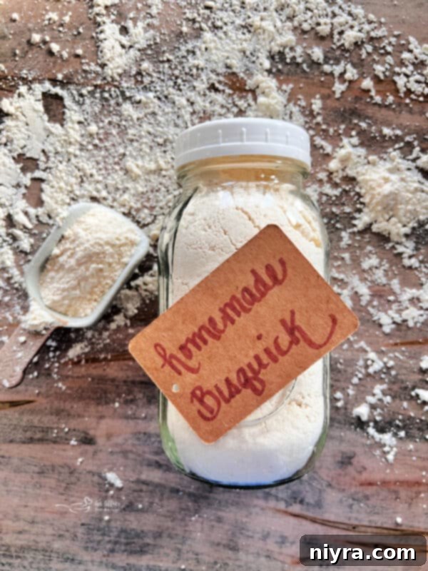 Homemade Bisquick Mix in a glass jar with a spoon