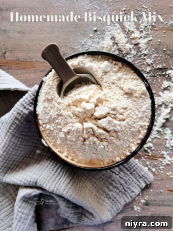 A bowl of homemade bisquick mix with a scoop