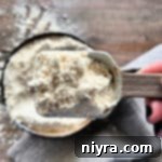 Homemade bisquick up close on a measuring spoon