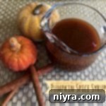 Cozy Pumpkin Spice Syrup 2 Pumpkin Spice Syrup in a glass measuring cup, ready to be strained