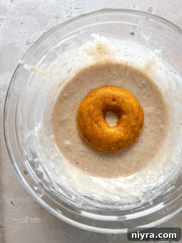 Freshly baked pumpkin donuts cooling on a wire rack, ready for glazing