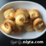 Close up of Quick Crescent Knots on a white plate, showing golden texture