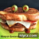 Close up of Pizza Monster Sandwich on a green plate