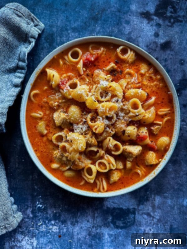 Chicken Parmesan Soup garnished with fresh basil