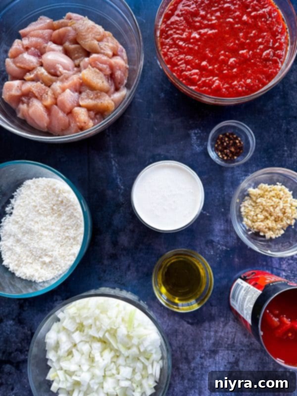 A bowl of creamy Chicken Parmesan Soup with a spoon