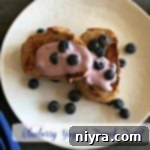 overhead of french toast on a white plate with text 'Blueberry Yogurt French Toast'