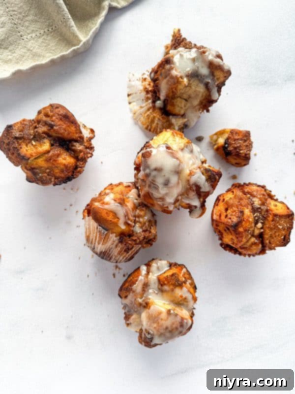 A close-up of a Toffee Monkey Bread Muffin, showing its sticky, golden interior and bits of toffee.