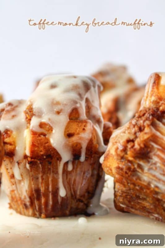 A close-up shot of Toffee Monkey Bread Muffins, highlighting their texture and sticky, sweet glaze.