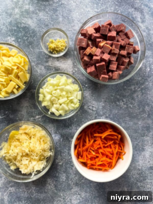 Reuben Chowder 4 Fresh ingredients laid out for Cream of Reuben Soup: chicken stock, corned beef, sauerkraut, onion, garlic, oregano, white pepper, bay leaf, water, cornstarch, carrots, Swiss cheese, and heavy cream.