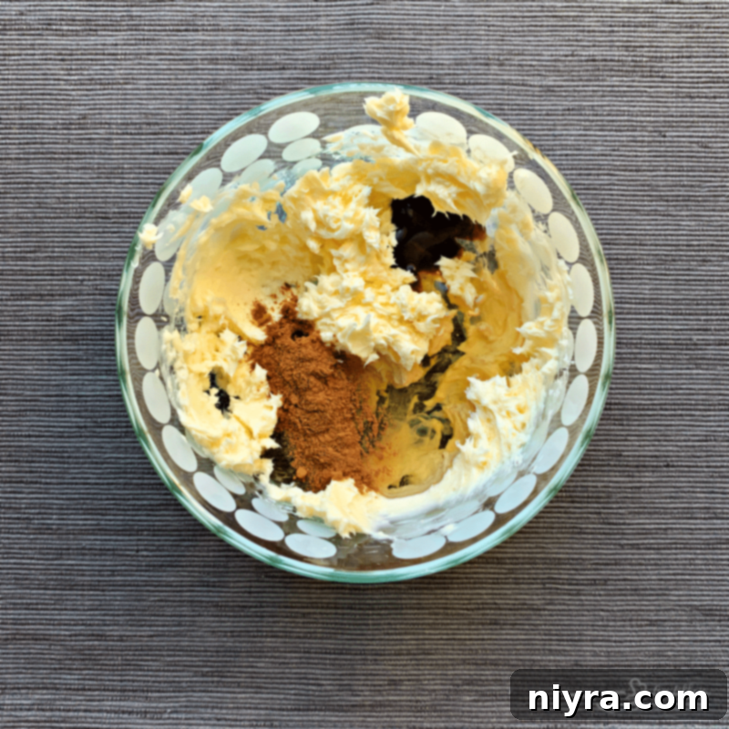 Close-up of butter being creamed in a bowl before other ingredients are added.