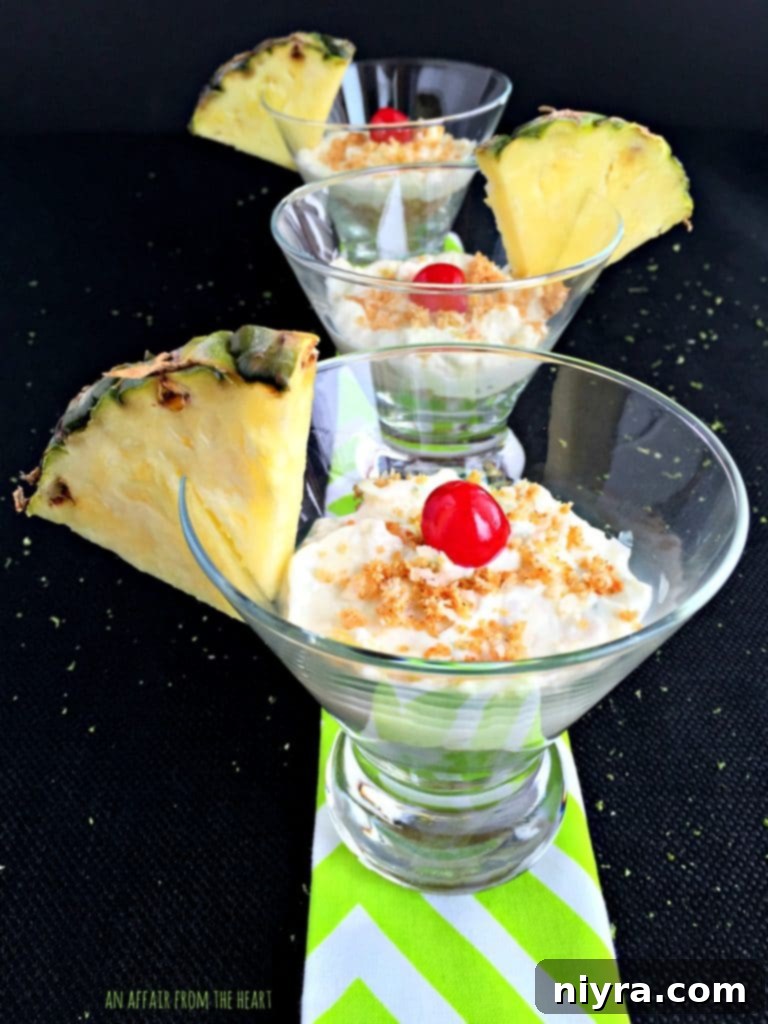 Finished Pina Colada Cheesecake Shooters with pineapple garnish