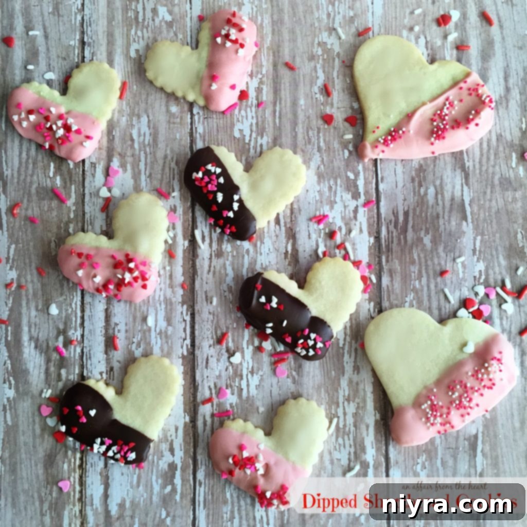 Enrobed Shortbread Delights 2 Heart-shaped shortbread cookies dipped in chocolate and sprinkles, perfect for Valentine's Day.