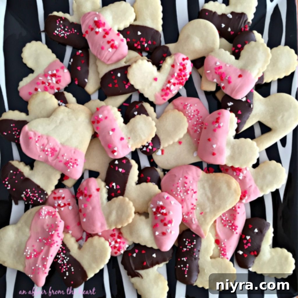 Enrobed Shortbread Delights 3 Close-up of golden brown shortbread cookies, some dipped in chocolate.