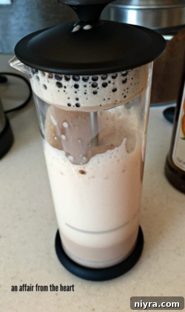 Golden Hour Mocha 6 Ninja Coffee Bar's integrated frother in action, creating creamy chocolate milk froth