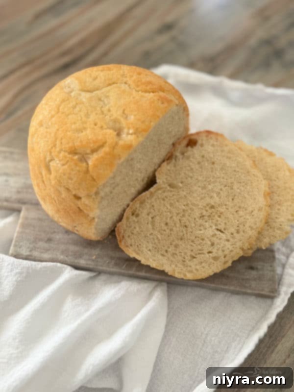one loaf of peasant bread on cutting board with slices